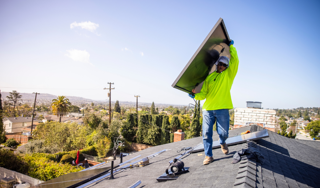 Worker carrying a solar panel