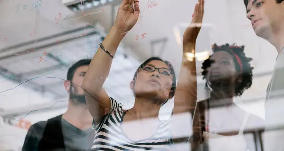 Group of people looking at a board