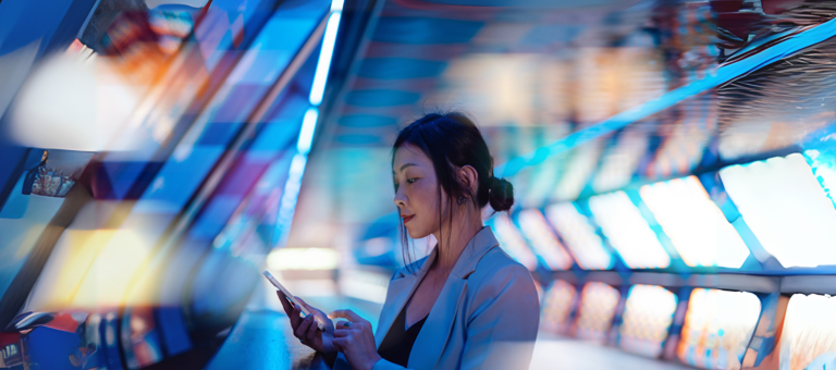 Young Asian business woman using smart phone in a Virtual Reality (VR) environment