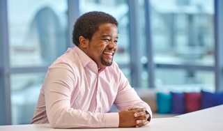 A man sitting in an office smiling