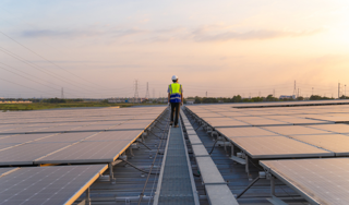 Engineers working at roof and inspect solar panels