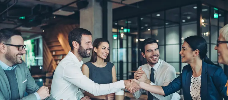 Two smiling people shaking hands
