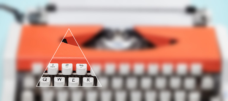 A triangle showing QWER keys set over a blurred typewriter
