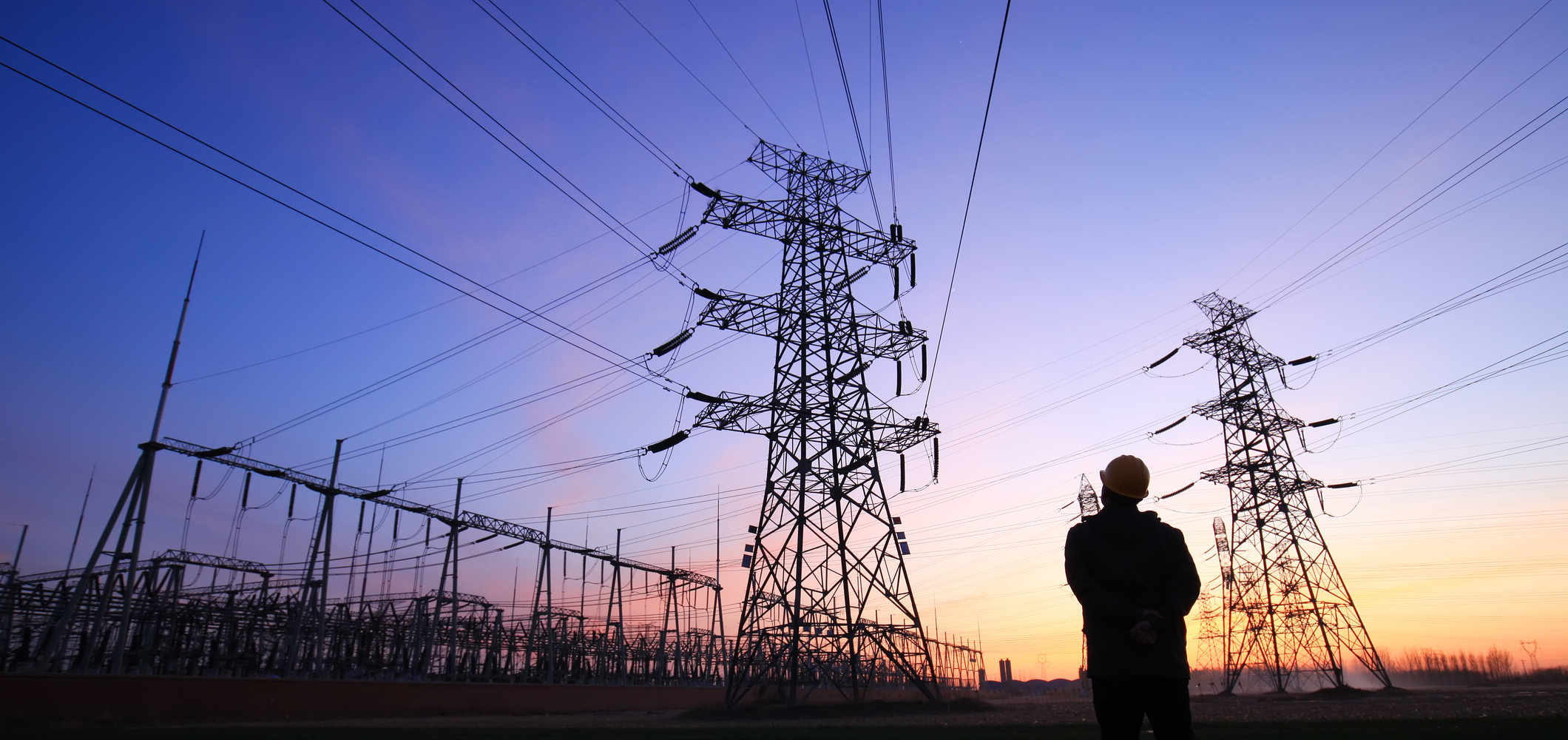 man looking at power lines