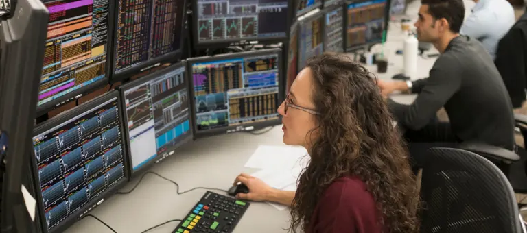 Young traders analyzing computer data
