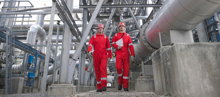 Two workers in an energy facility
