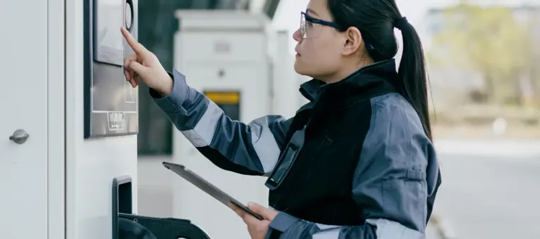 A woman inspecting a battery storage unit