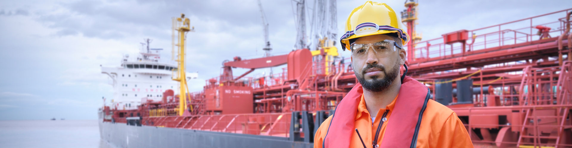 ship worker on tugboat with tanker