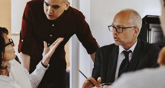 Three people talking during a meeting