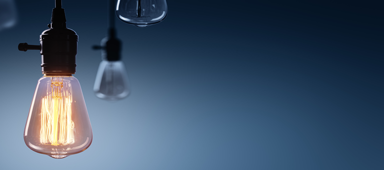 A collection of light bulbs with one illuminated