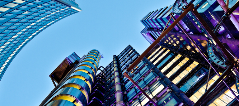 Looking upwards at glass-fronted buildings