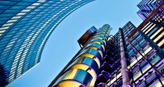 Looking upwards at glass-fronted buildings