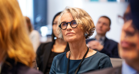 Senior business woman with glasses looking into distance