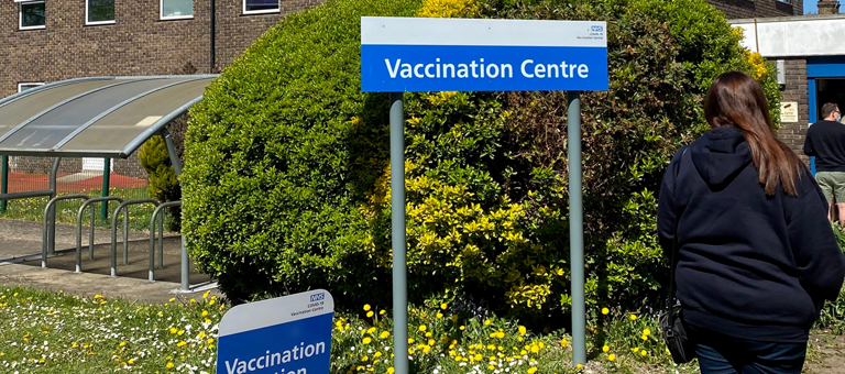 People queueing outside an NHS vaccination centre