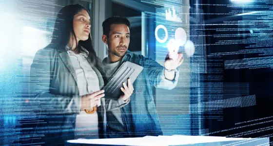 Two people reviewing information on a screen