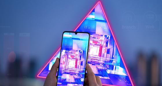 Hand holding a smartphone in front of data graphs