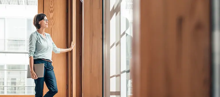 Standing woman opening a door