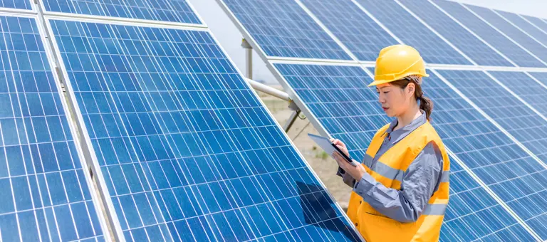 Woman working on solar panels