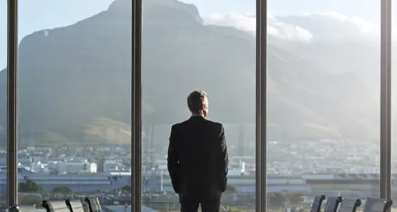 business man in office looking at view