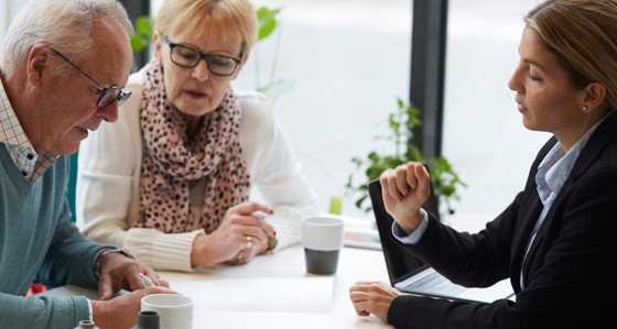 An advisor talking to an elderly couple