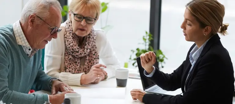 An advisor talking to an elderly couple