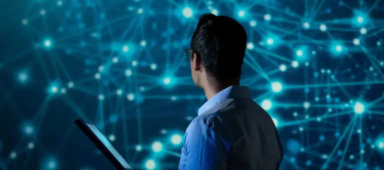 IT Specialist using tablet computer in front of big screen