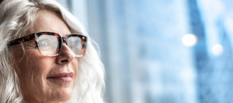 Mature business woman looking out window