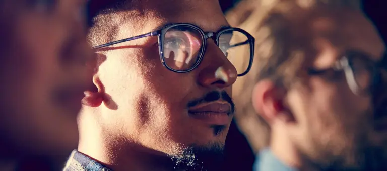 Man with glasses looking into the distance