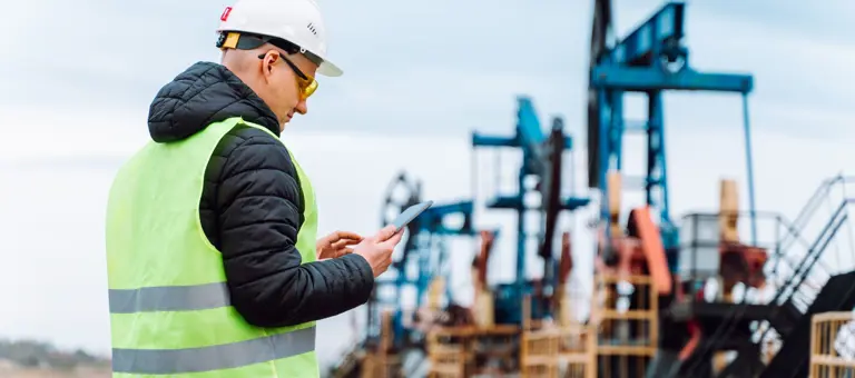 Worker inspecting an oil extraction site