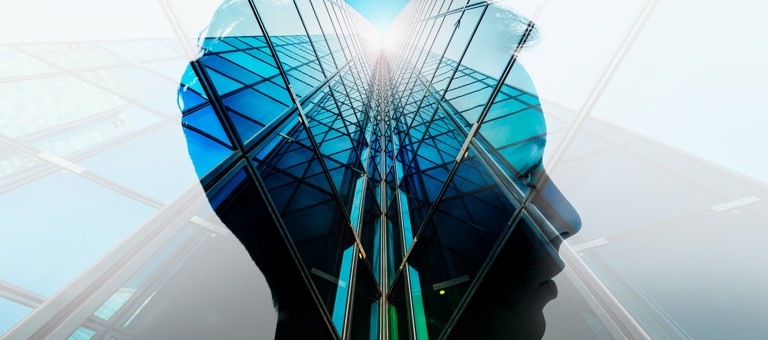 A human head superimposed over a upwards view of a skyscraper