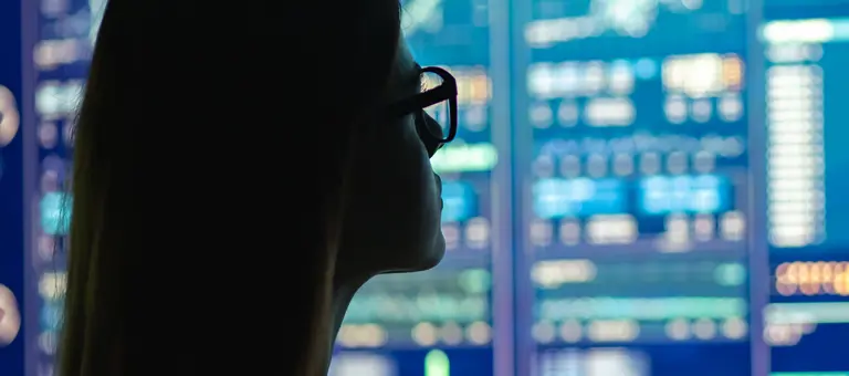 A woman looking at digital screens