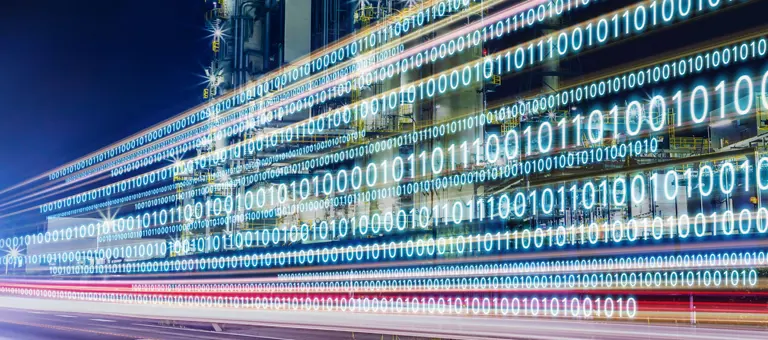 An industrial building at night with digital numerals overlay