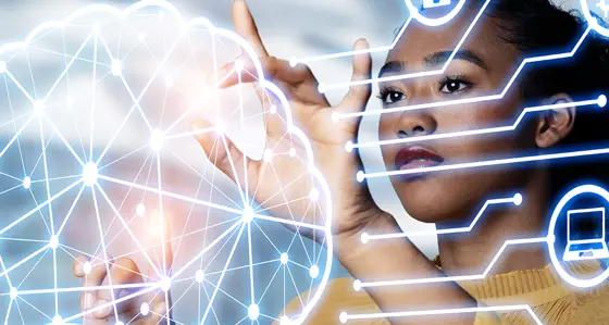 A woman touching holographic image of brain surrounded by icons