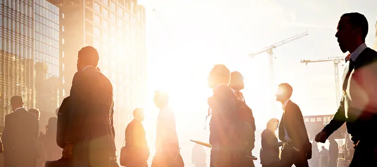 Business people crossing the road in a busy city