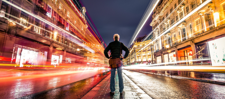 Man in city at night with bright light