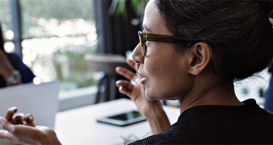 A woman in conversation with a colleague