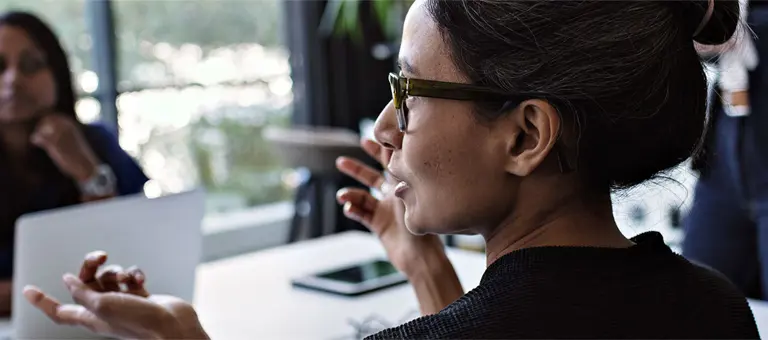 A woman in conversation with a colleague