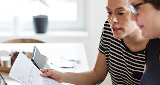 Two people looking at a report