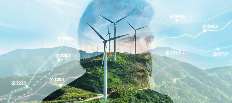 A man's head and index prices superimposed over a green hillside with a wind turbine