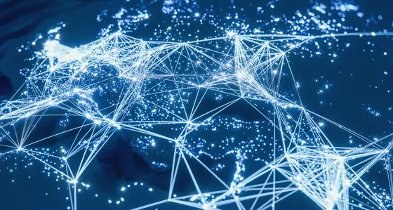 The world lit up at night with cities connected by lines of lights representing networks
