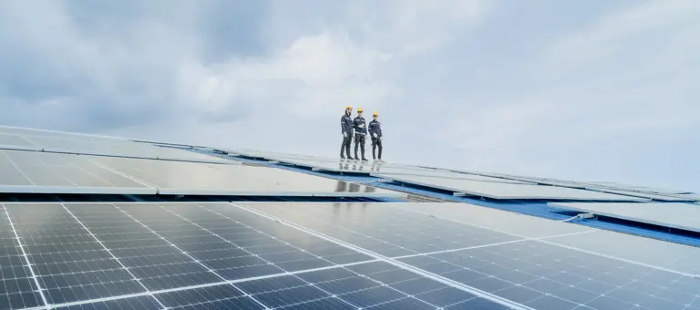 solar panel workers on solar panels