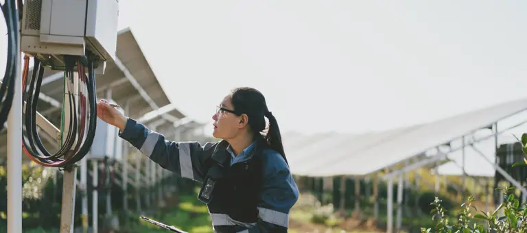 asian female engineer working on solar panel plant