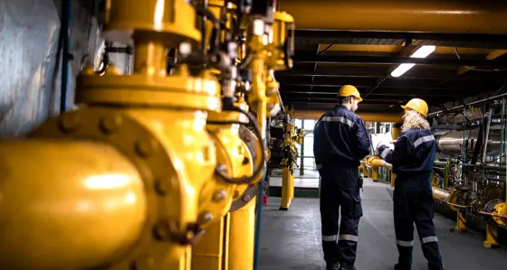 Workers walking inside a gas facility