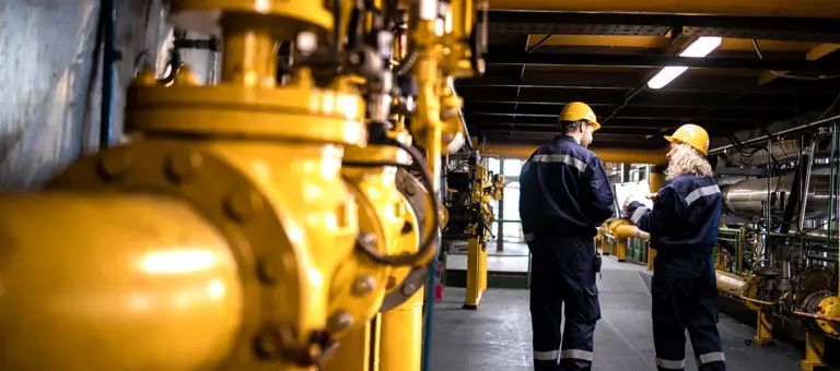 Workers walking inside a gas facility