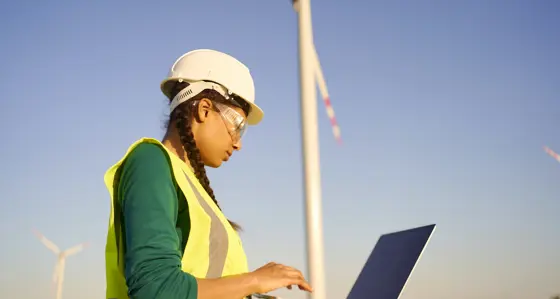Female engineer setting up wind turbine