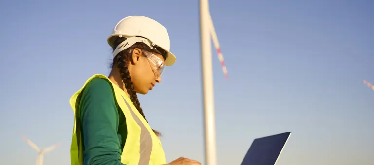 Female engineer setting up wind turbine