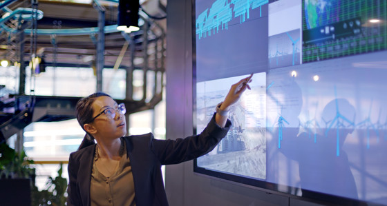 Woman pointing at a large screen