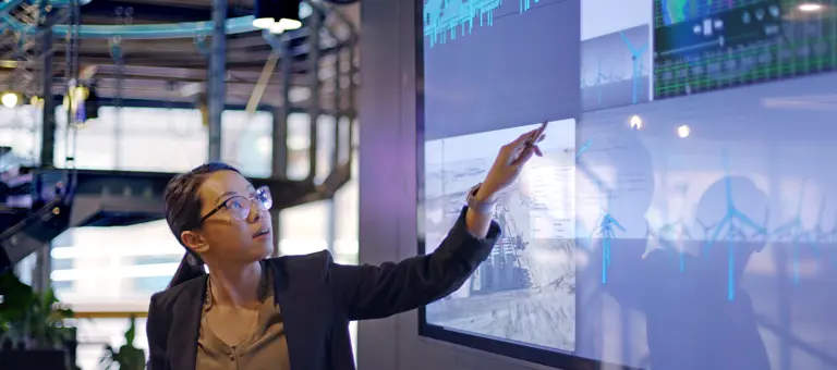Woman pointing at a large screen