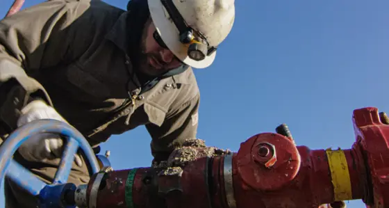 An engineer tightening up a valve in pipework