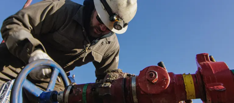 An engineer tightening up a valve in pipework